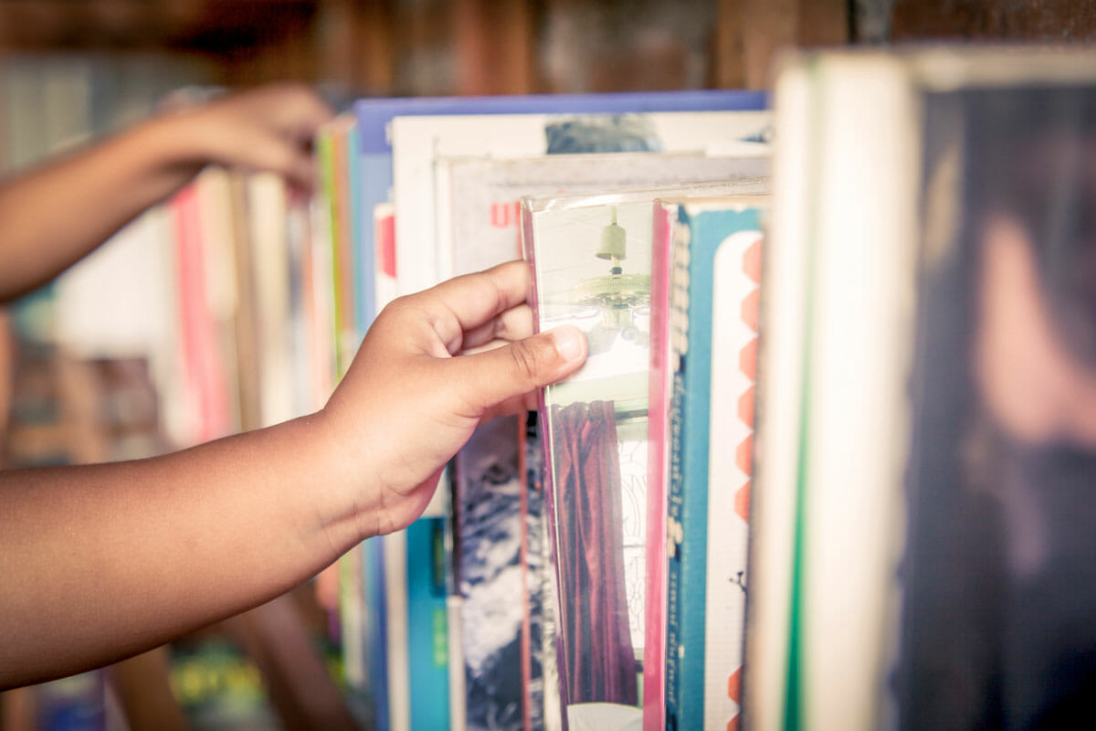 Hands putting away library books