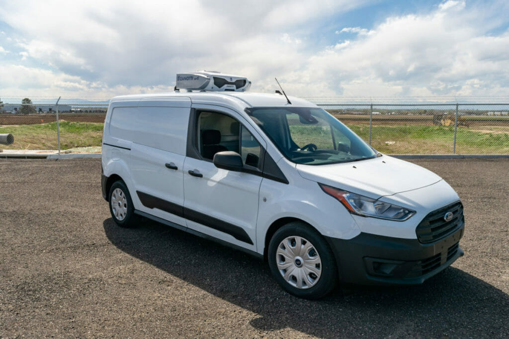 Side view of a Ford Transit Connect being outfitted as a refrigerated vehicle